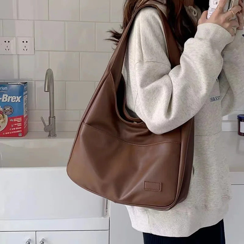 Large capacity tote bag, new black leather simple casual commuting women's bag, fashionable and versatile single shoulder bag